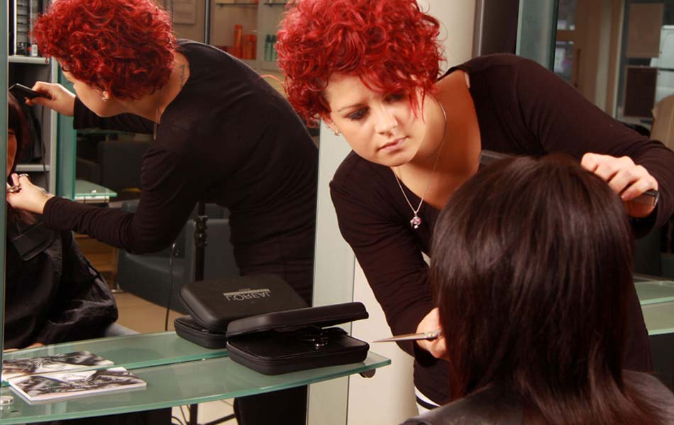 Girl with red hair cutting hair
